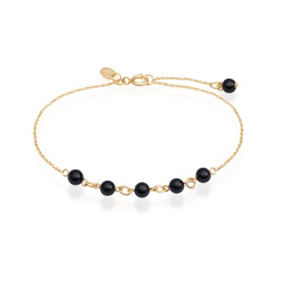 Forgyldt armbnd med sorte onyx-sten. Justerbar lngde og elegant kontrast mellem glansfuld sten og gyldent metal.